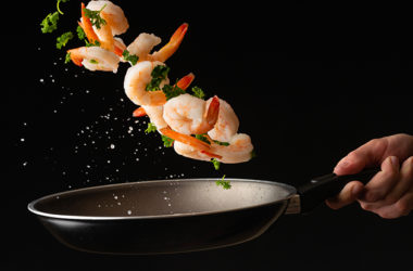 Sea food, cooking shrimp with herbs, on a dark background, horizontal photo, healthy and wholesome food